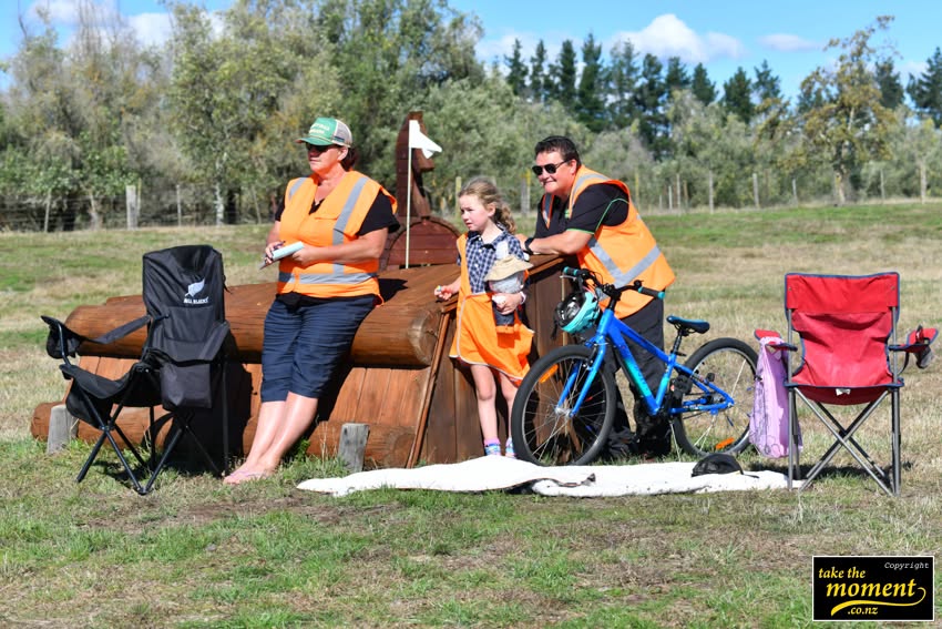 Volunteers and a young helper on the cross country course